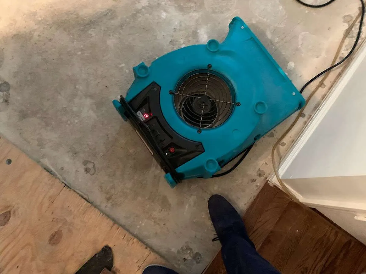 Air mover drying subfloor during Leak Detection & Repair in Groton